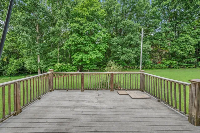 a view of yard with swimming pool and green space