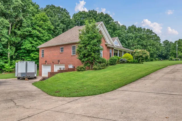 a view of a house with a yard and sitting area