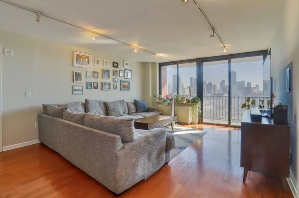a living room with furniture and kitchen view