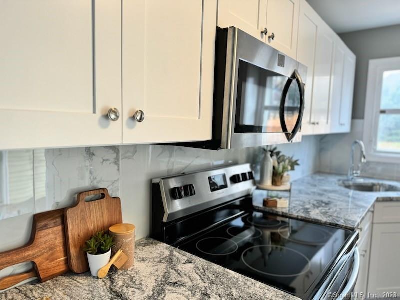 a kitchen with a sink stove and microwave