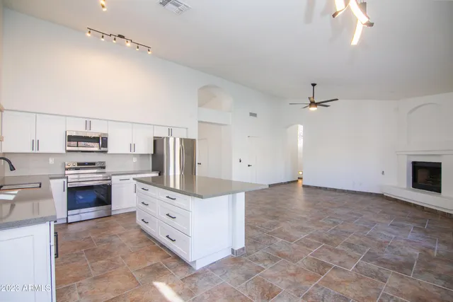 a large kitchen with cabinets and stainless steel appliances