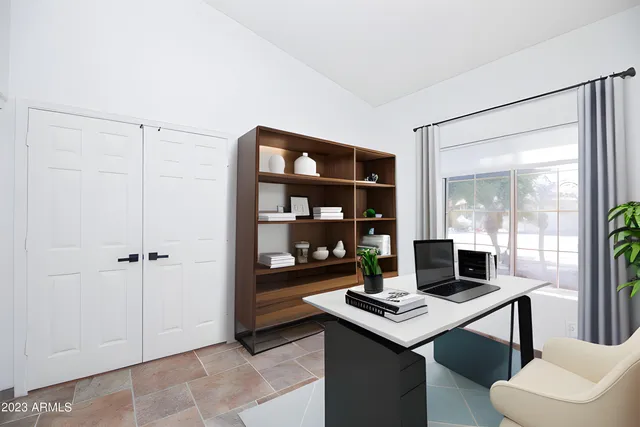 a view of a workspace with furniture and a potted plant