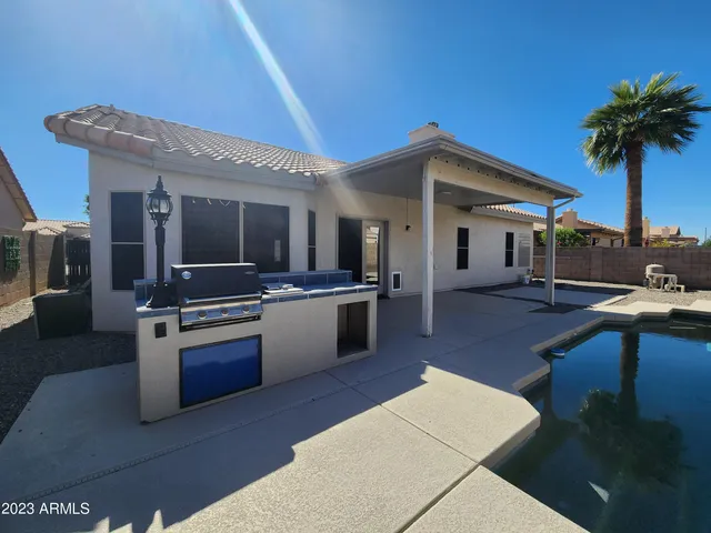 a kitchen with stainless steel appliances granite countertop a sink a stove top oven a counter space and cabinets