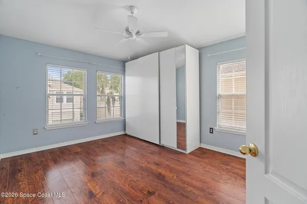 a view of empty room with wooden floor