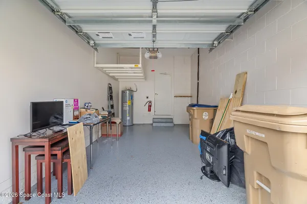 a front view of a house with a garden and parking space