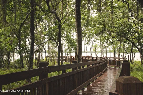 a view of a patio with a dining table and chairs with wooden floor