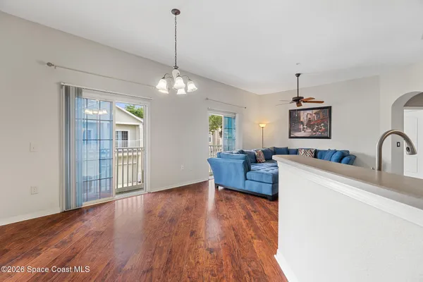a living room with furniture and a chandelier