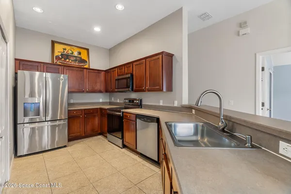 a kitchen with a sink stove and microwave