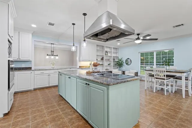 a kitchen with stove a sink and cabinets