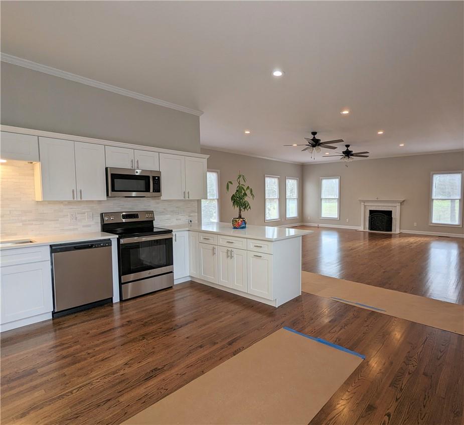 2619 Hinson Road Monroe, NC 28112 - Photo 14 of 39 a large kitchen with cabinets wooden floor and stainless steel appliances