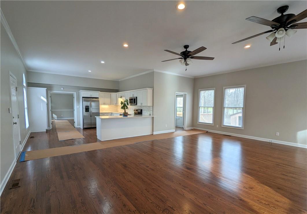 2619 Hinson Road Monroe, NC 28112 - Photo 15 of 39 a view of an empty room with a window and wooden floor