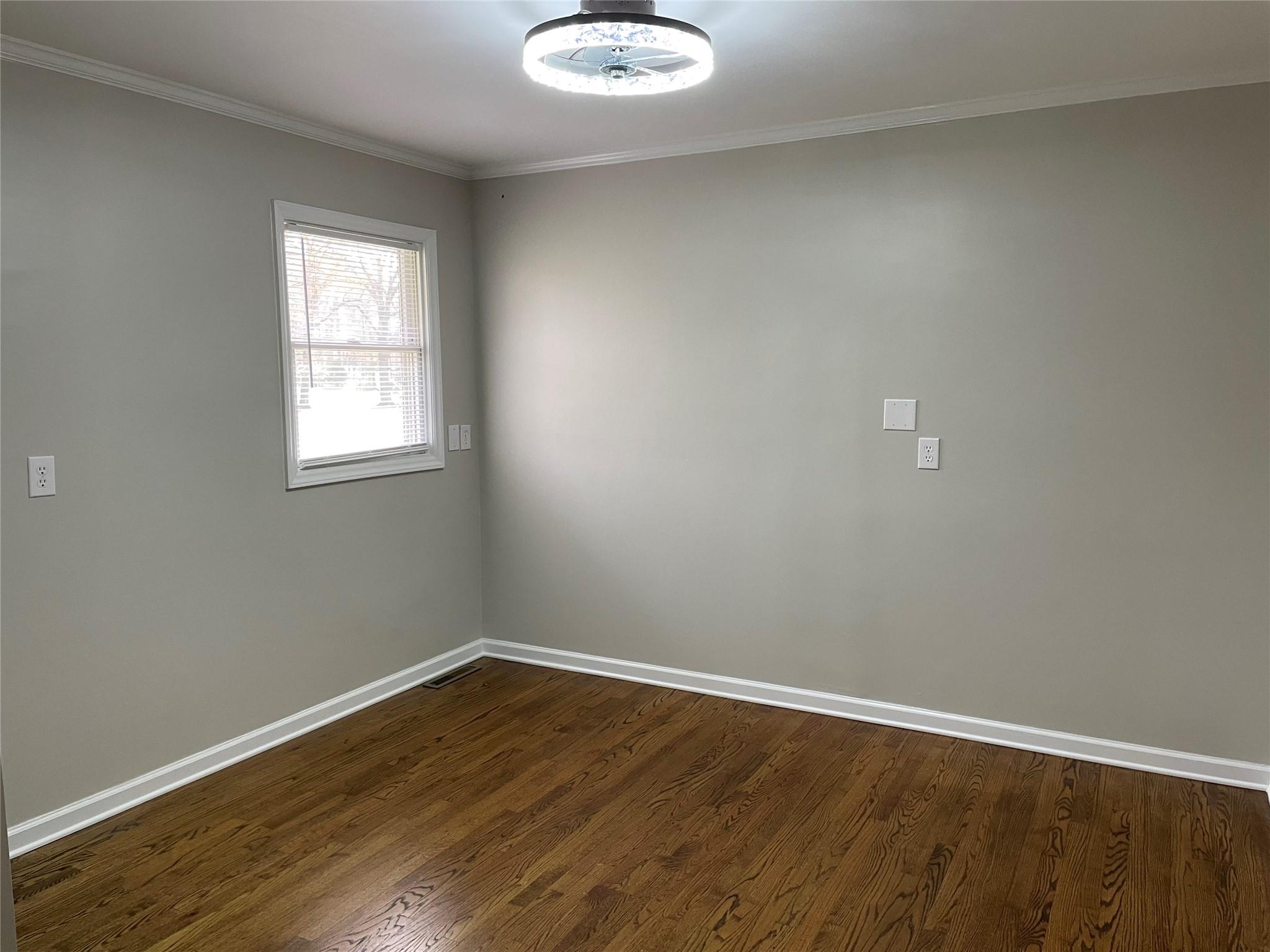 2619 Hinson Road Monroe, NC 28112 - Photo 23 of 39 an empty room with wooden floor and windows