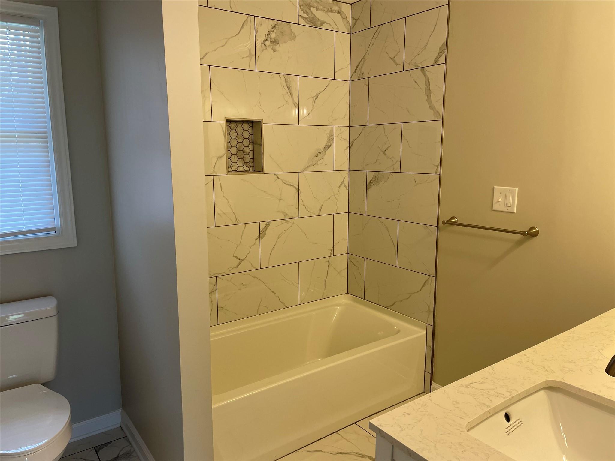 2619 Hinson Road Monroe, NC 28112 - Photo 24 of 39 a bath tub sitting next to a white toilet and a sink