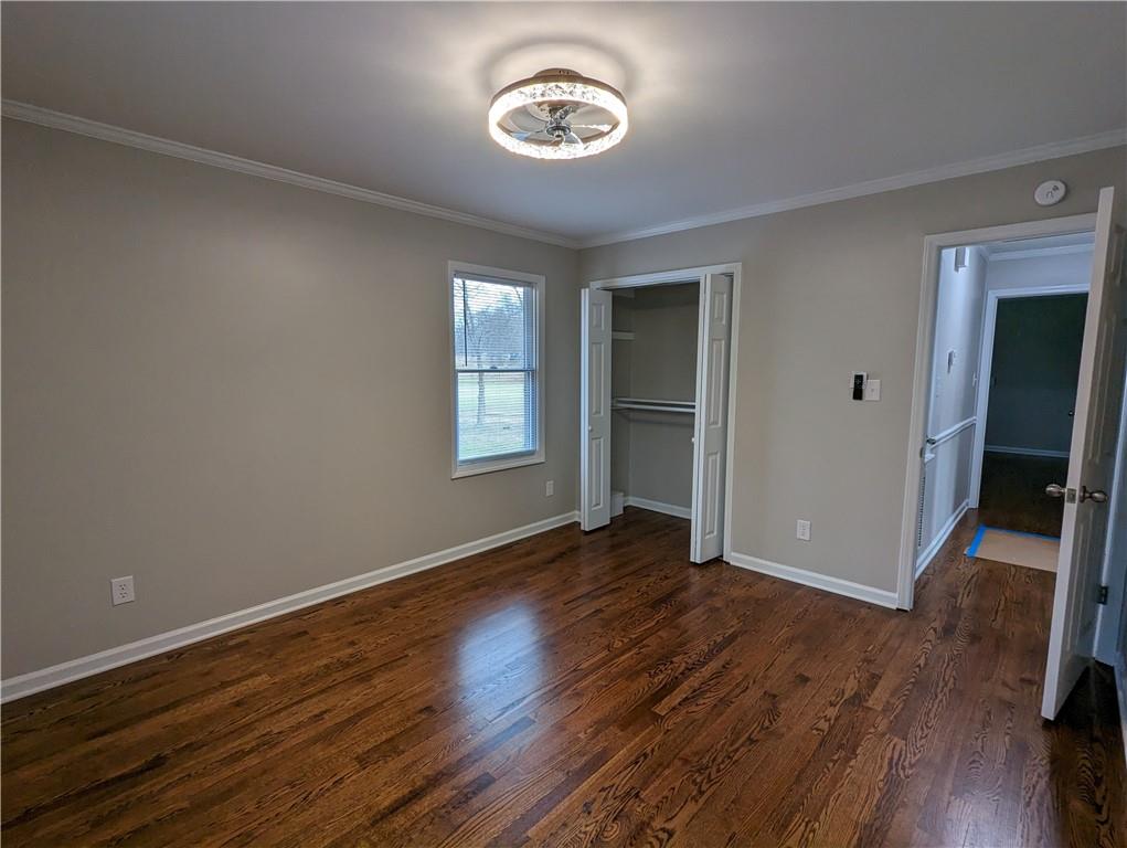 2619 Hinson Road Monroe, NC 28112 - Photo 27 of 39 an empty room with wooden floor closet and windows