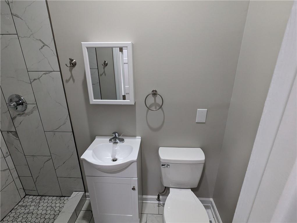 2619 Hinson Road Monroe, NC 28112 - Photo 28 of 39 a bathroom with a toilet sink and mirror