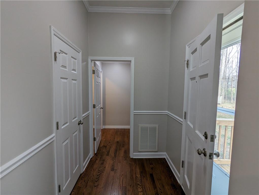 2619 Hinson Road Monroe, NC 28112 - Photo 30 of 39 a view of a hallway with wooden floor and staircase