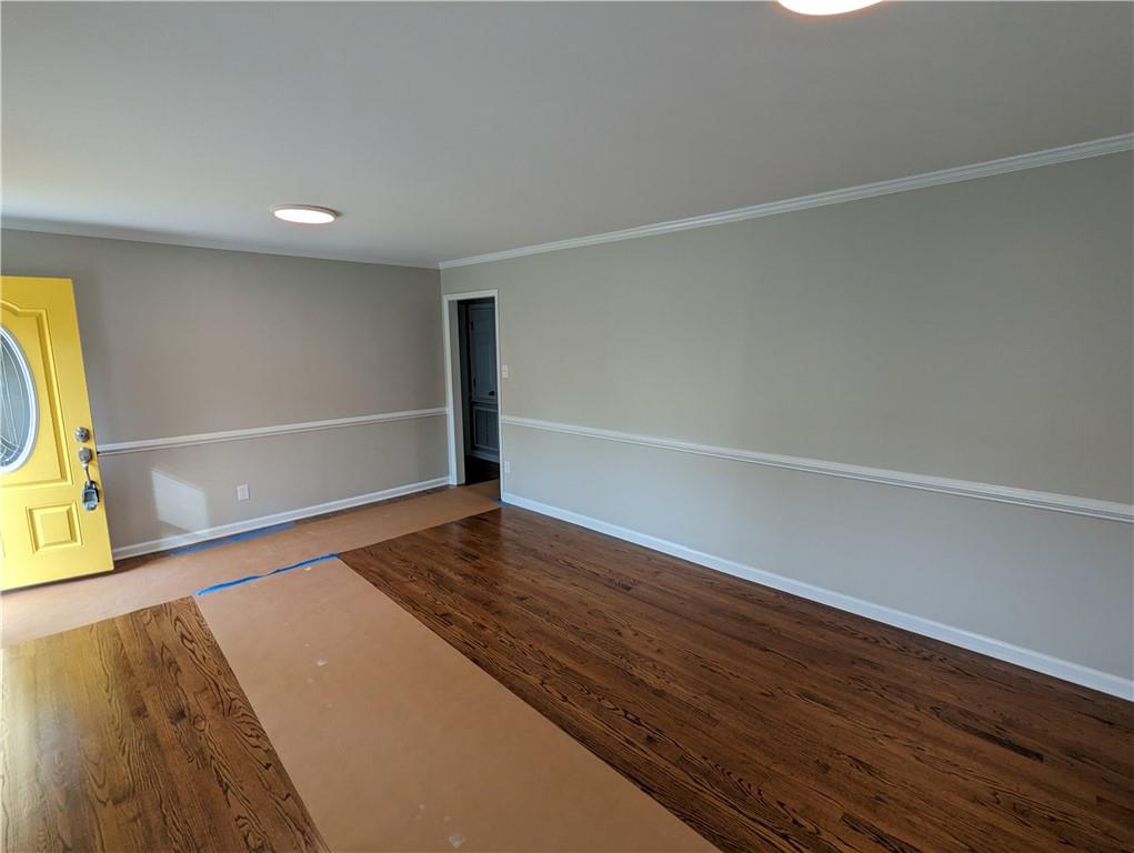 2619 Hinson Road Monroe, NC 28112 - Photo 4 of 39 a view of an empty room with wooden floor and a window
