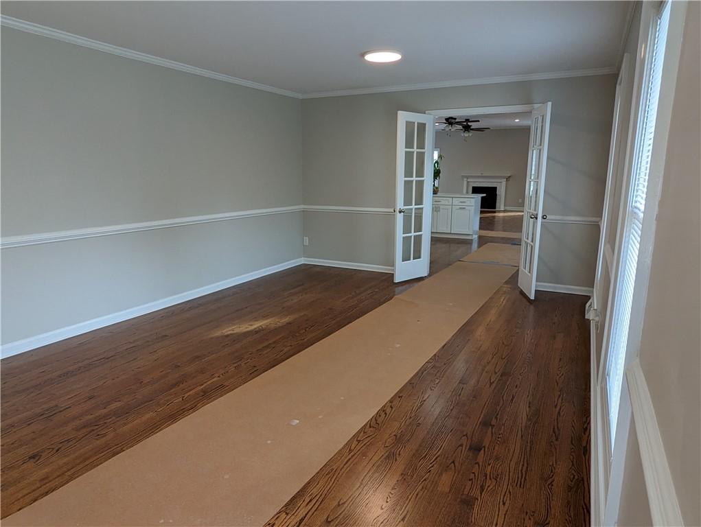 2619 Hinson Road Monroe, NC 28112 - Photo 6 of 39 a view of a hallway with wooden floor and a refrigerator
