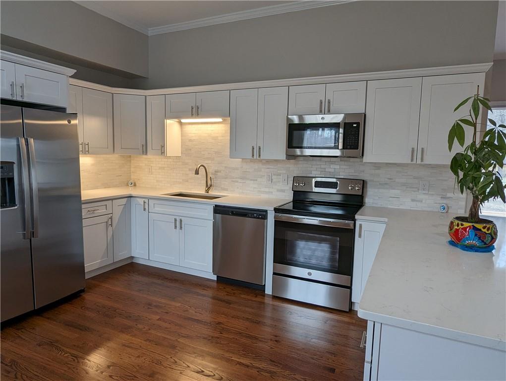 2619 Hinson Road Monroe, NC 28112 - Photo 7 of 39 a kitchen with granite countertop a refrigerator stove and microwave