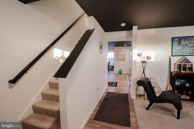 a hallway with furniture and stairs