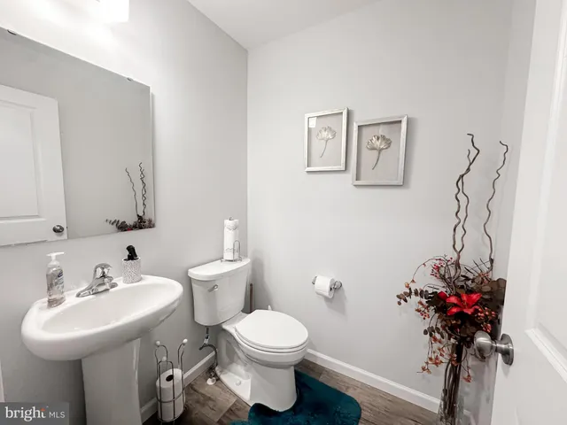 a bathroom with a sink toilet and a mirror