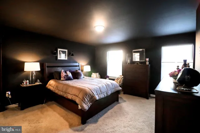 a bedroom with a bed and a lamp