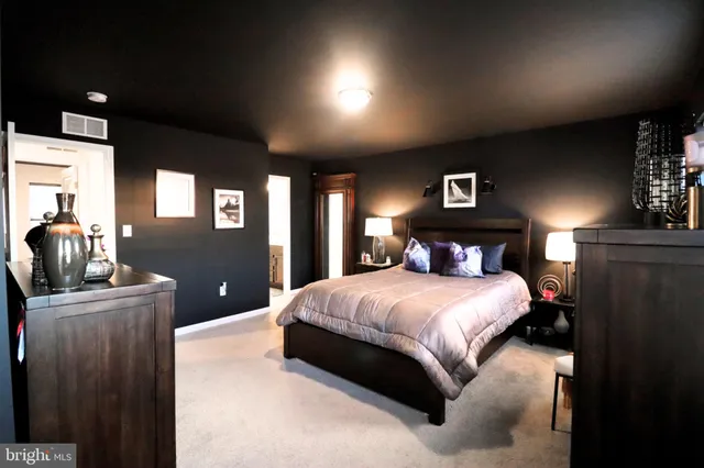 a bedroom with a bed and a large mirror