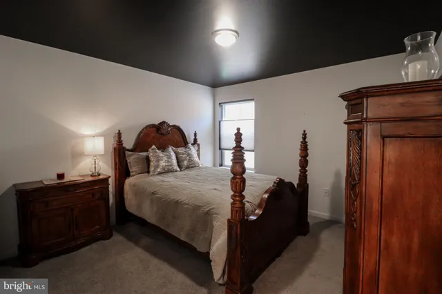 a bed room with a bed and a dresser