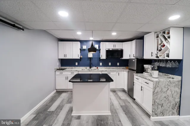 a kitchen with a white stove top oven and white cabinets