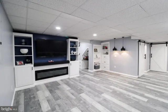 a view of an empty room with closet and window