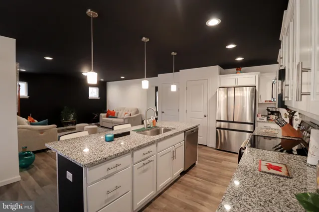 a kitchen with a sink appliances and cabinets