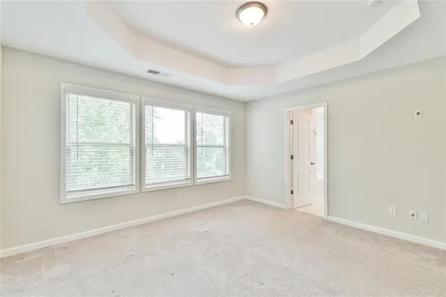 an empty room with a empty space and windows