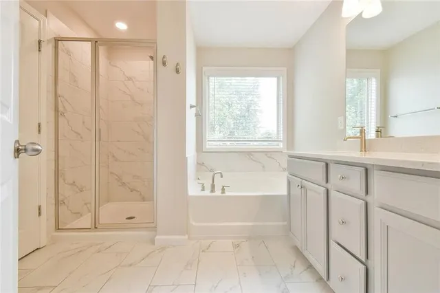 a bathroom with a shower a sink and a bathtub