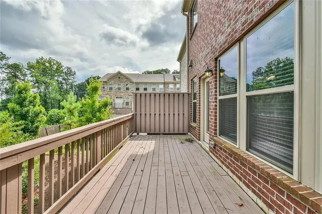 a balcony with wooden floor and fence