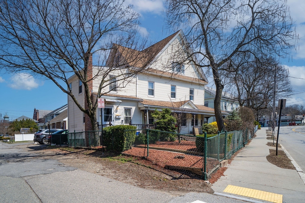 17-19 Crafts Street Newton, MA 02458 - Photo 1 of 24 a view of a white house with large trees and wooden fence