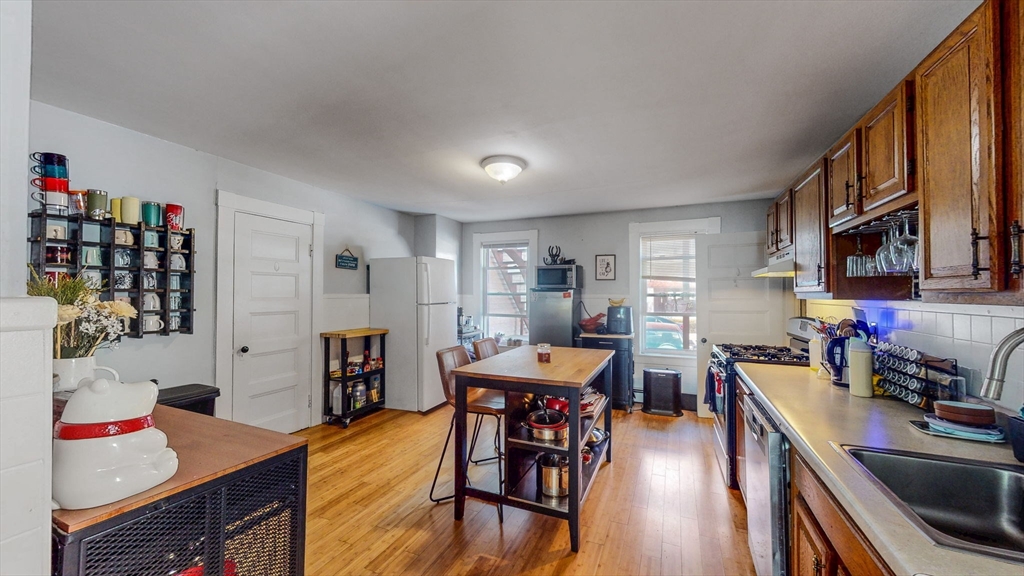 17-19 Crafts Street Newton, MA 02458 - Photo 15 of 24 a open dining room with stainless steel appliances furniture a rug and a kitchen view