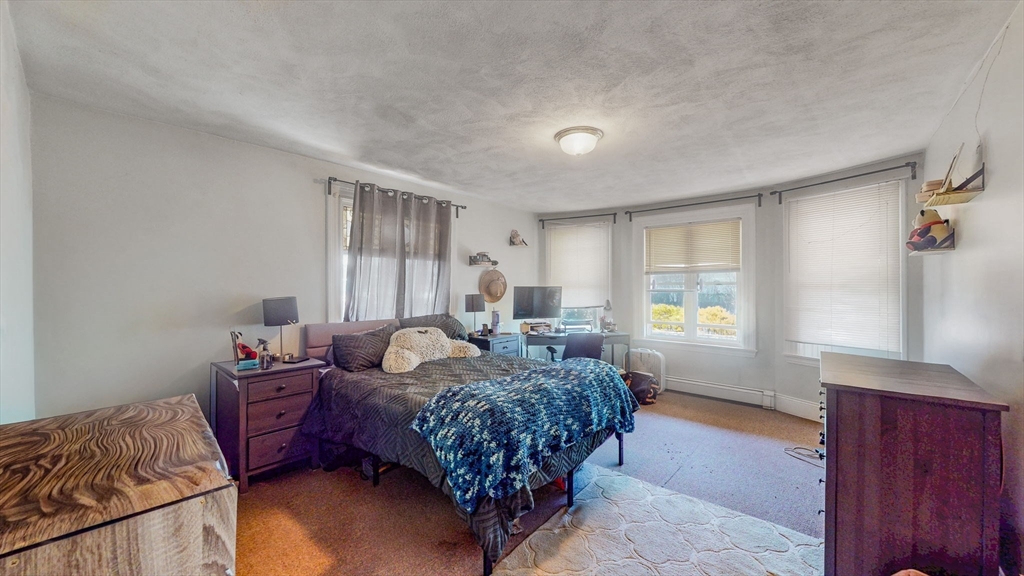 17-19 Crafts Street Newton, MA 02458 - Photo 17 of 24 a bed room with a bed and a window