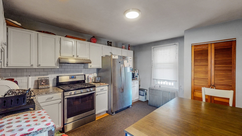 17-19 Crafts Street Newton, MA 02458 - Photo 3 of 24 a kitchen with stainless steel appliances a refrigerator stove and cabinets