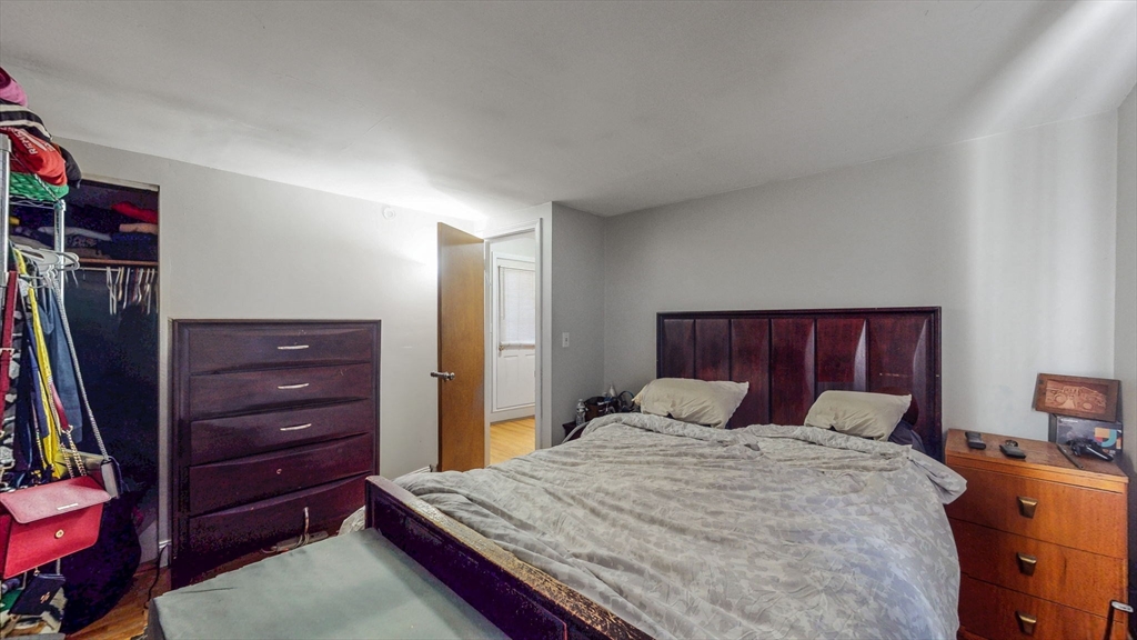 17-19 Crafts Street Newton, MA 02458 - Photo 6 of 24 a bedroom with a bed and a dresser