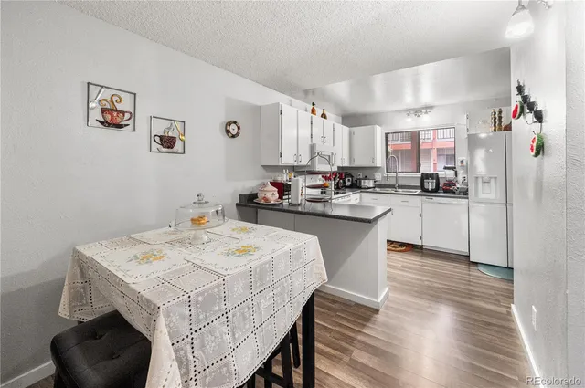 a kitchen with a sink a stove a refrigerator and cabinets