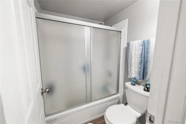a bathroom with a shower and a toilet