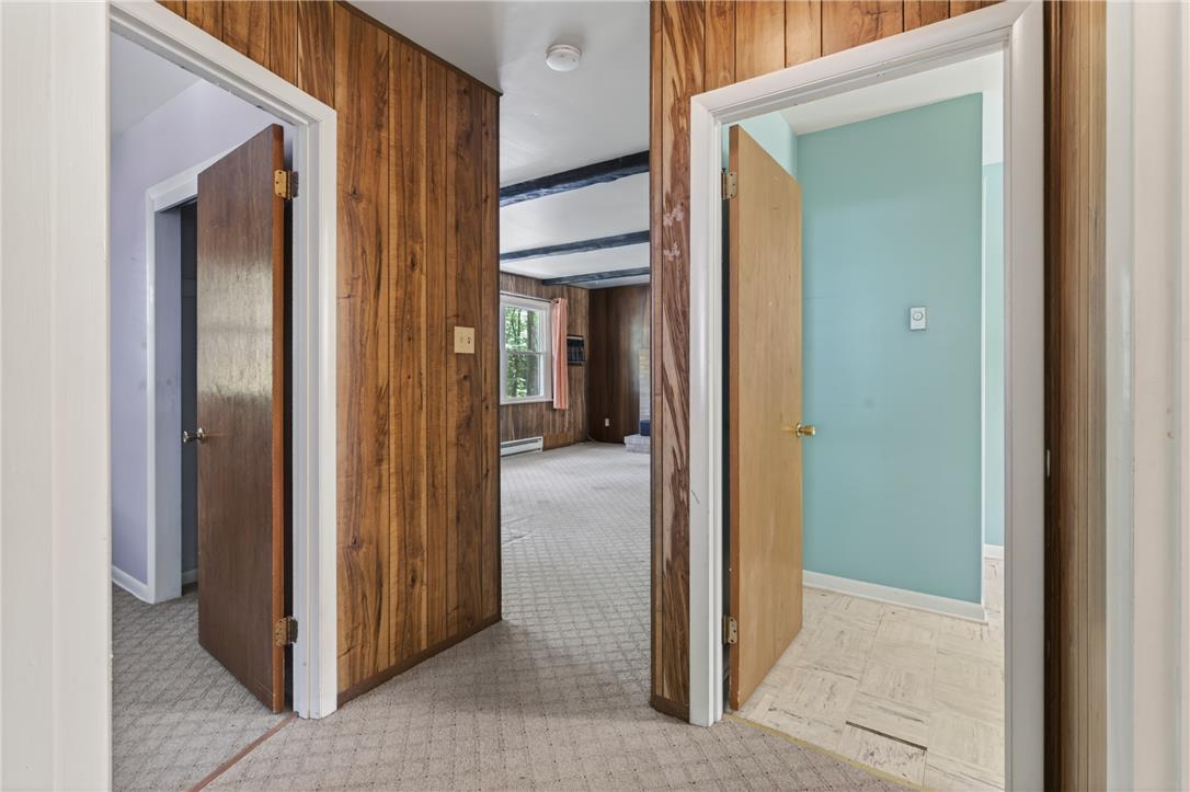 18 White Oak Road Nesquehoning, PA 18240 - Photo 30 of 52 Natural wood paneling adorns a central hallway, leading to inviting interior spaces.