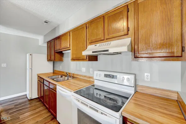 a kitchen with stainless steel appliances granite countertop a stove and a refrigerator