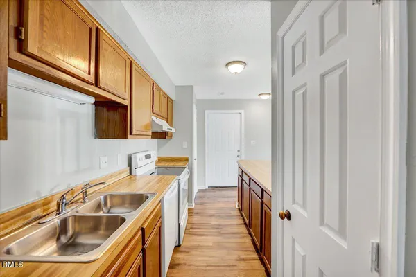 a kitchen with a sink and a refrigerator