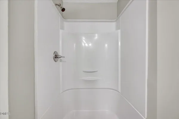 a bathroom with a glass shower door