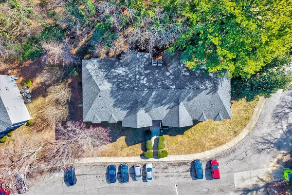 an aerial view of a house with swimming pool and porch