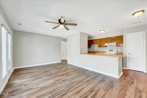 a view of a kitchen with wooden floor and a sink