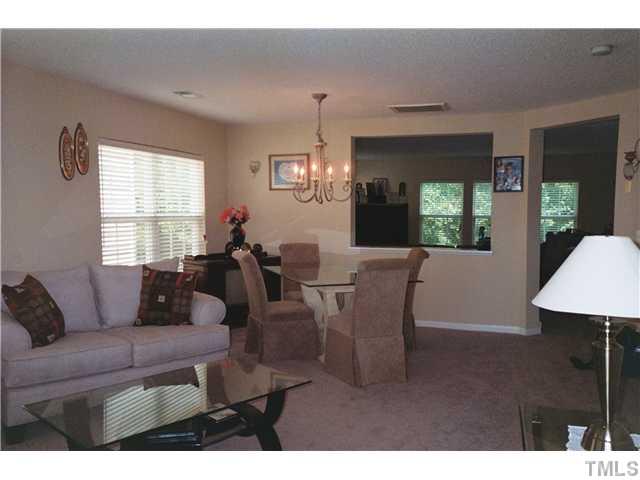 5955 Ricker Road Raleigh, NC 27610 - Photo 3 of 20 a living room with furniture a window and a chandelier