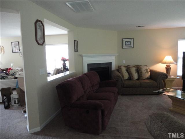5955 Ricker Road Raleigh, NC 27610 - Photo 4 of 20 a living room with furniture and a fireplace