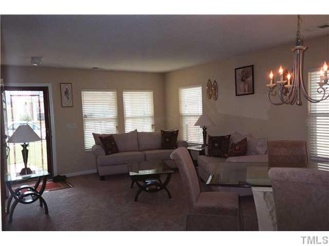 5955 Ricker Road Raleigh, NC 27610 - Photo 5 of 20 a living room with furniture and a flat screen tv